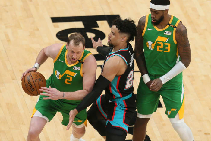 Joe Ingles (2) drives past Dillon Brooks (black 23) while Royce O'Neale (green 23) sets a pick
